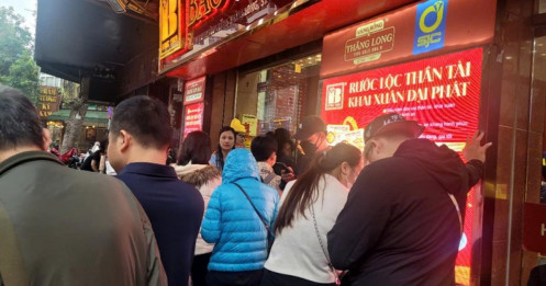 Người dân đội mưa xếp hàng chờ mua vàng trước ngày vía Thần Tài